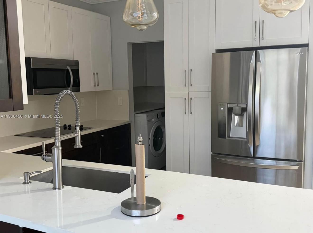 965 Southwest 153rd Path Miami, FL 33194 - Photo 13 of 27 a kitchen with stainless steel appliances refrigerator and microwave