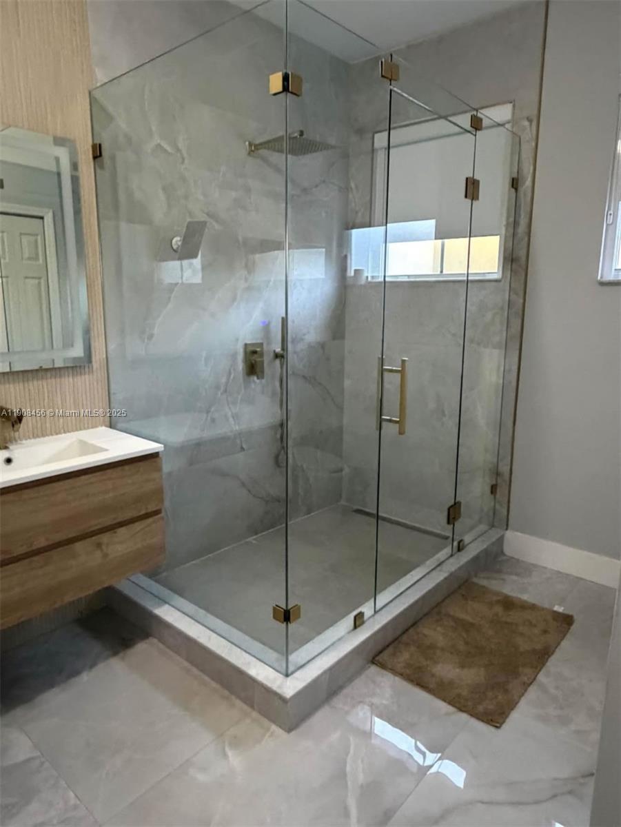 965 Southwest 153rd Path Miami, FL 33194 - Photo 22 of 27 a bathroom with a shower a mirror and a sink