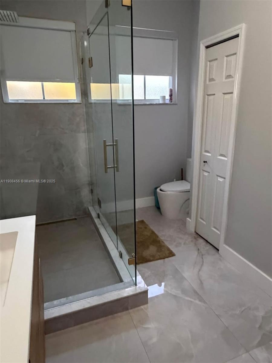 965 Southwest 153rd Path Miami, FL 33194 - Photo 23 of 27 a bathroom with a toilet and a shower
