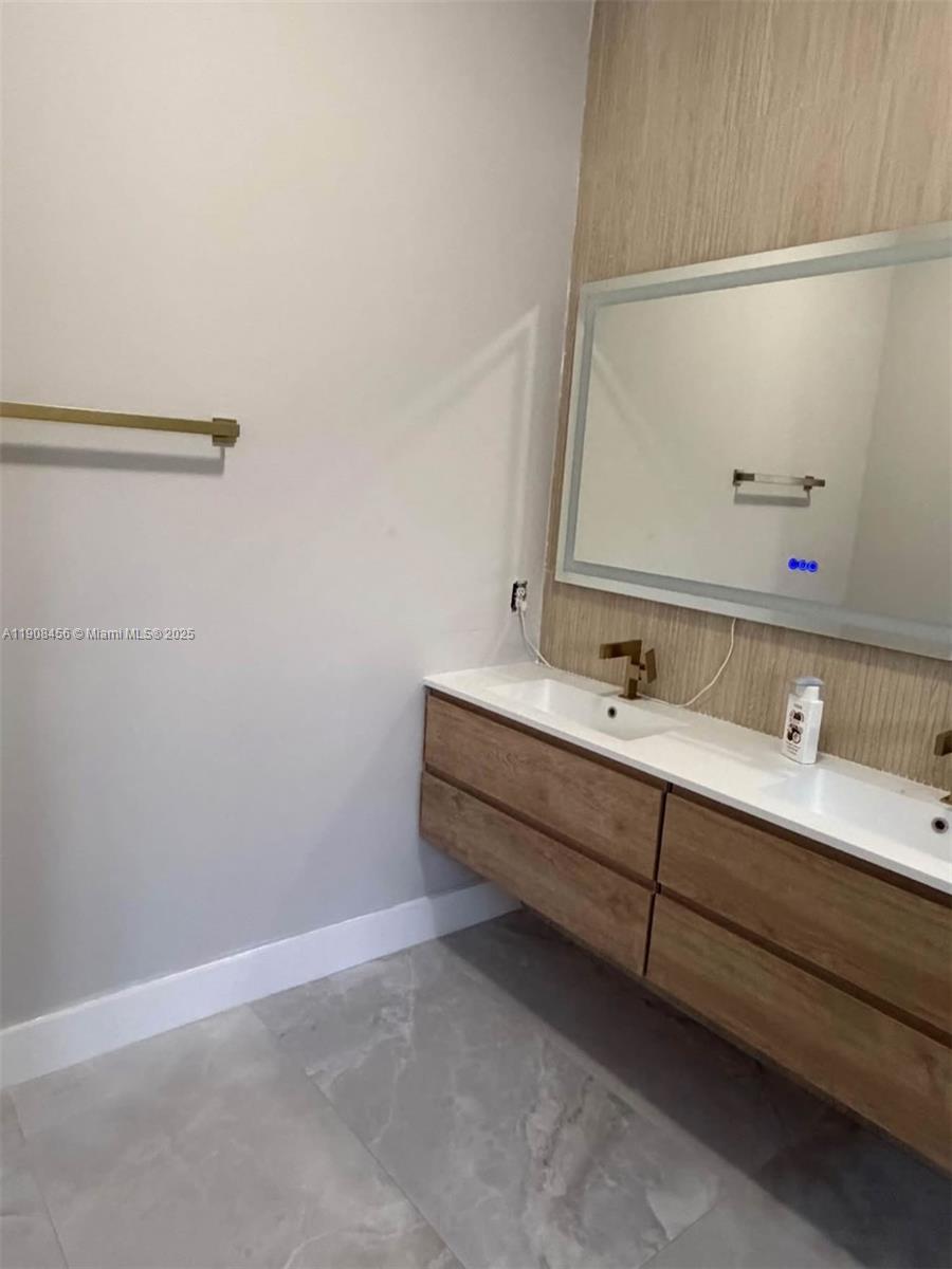 965 Southwest 153rd Path Miami, FL 33194 - Photo 24 of 27 a bathroom with a sink and a mirror