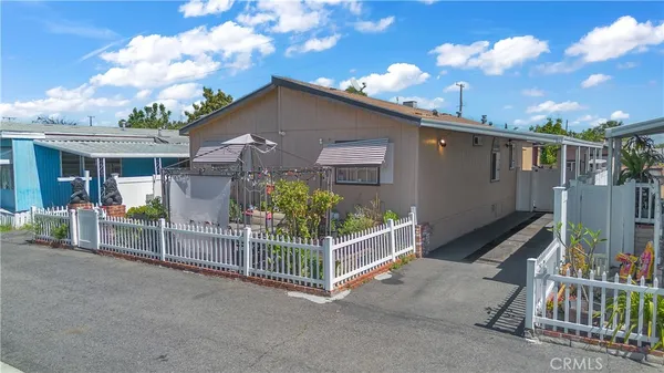 a view of a house with wooden fence