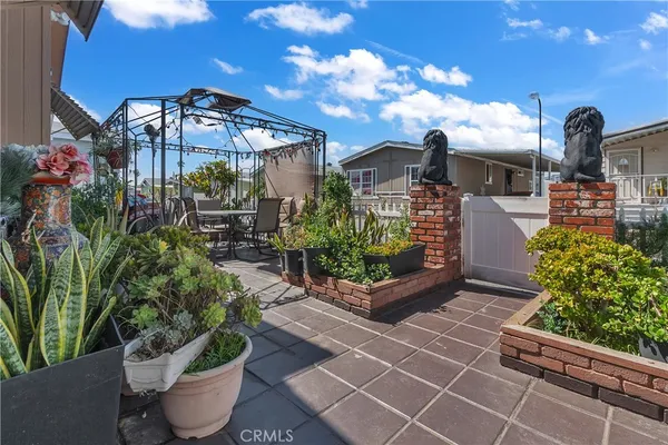 a view of a patio with table and chairs potted plants