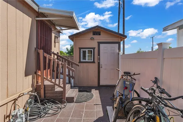 a view of a house with a small yard and furniture