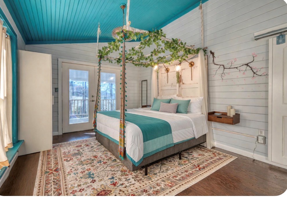 3035 Skeenah Gap Road Suches, GA 30572 - Photo 21 of 33 a bedroom with a bed and a chandelier