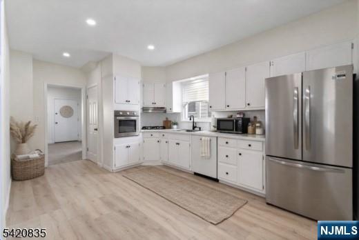 39 Hurden Street Hillside, NJ 07205 - Photo 6 of 20 a kitchen with stainless steel appliances a refrigerator sink and cabinets