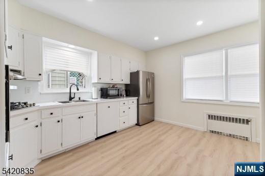 39 Hurden Street Hillside, NJ 07205 - Photo 8 of 20 a kitchen with stainless steel appliances a refrigerator sink and cabinets
