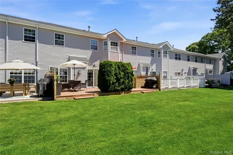 a view of a house with a yard and sitting area