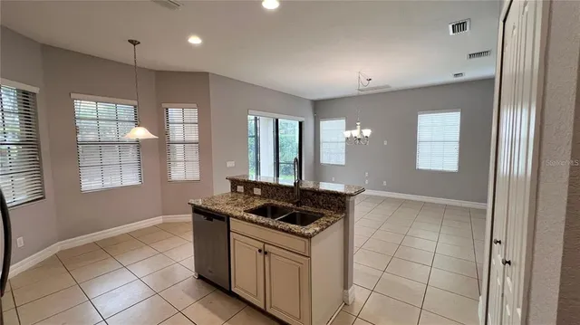 a bathroom with a granite countertop sink a toilet a mirror and shower