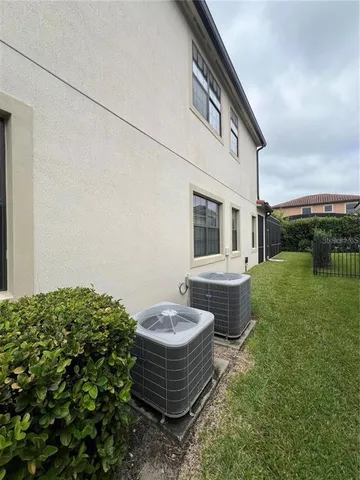 an aerial view of a house with a garden and large trees