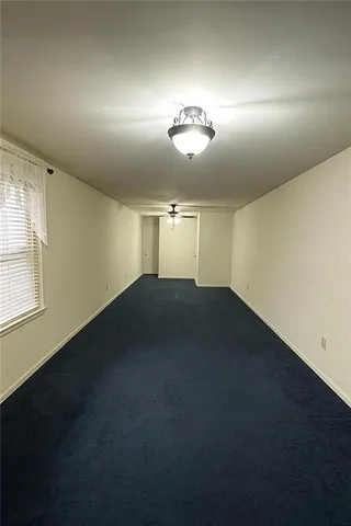 an empty room with a empty space and windows