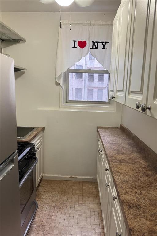 9801 Shore Road, Unit 2Q Brooklyn, NY 11209 - Photo 6 of 9 a kitchen with a stove and a sink