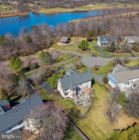 an aerial view of a house with a yard basket ball court and outdoor seating