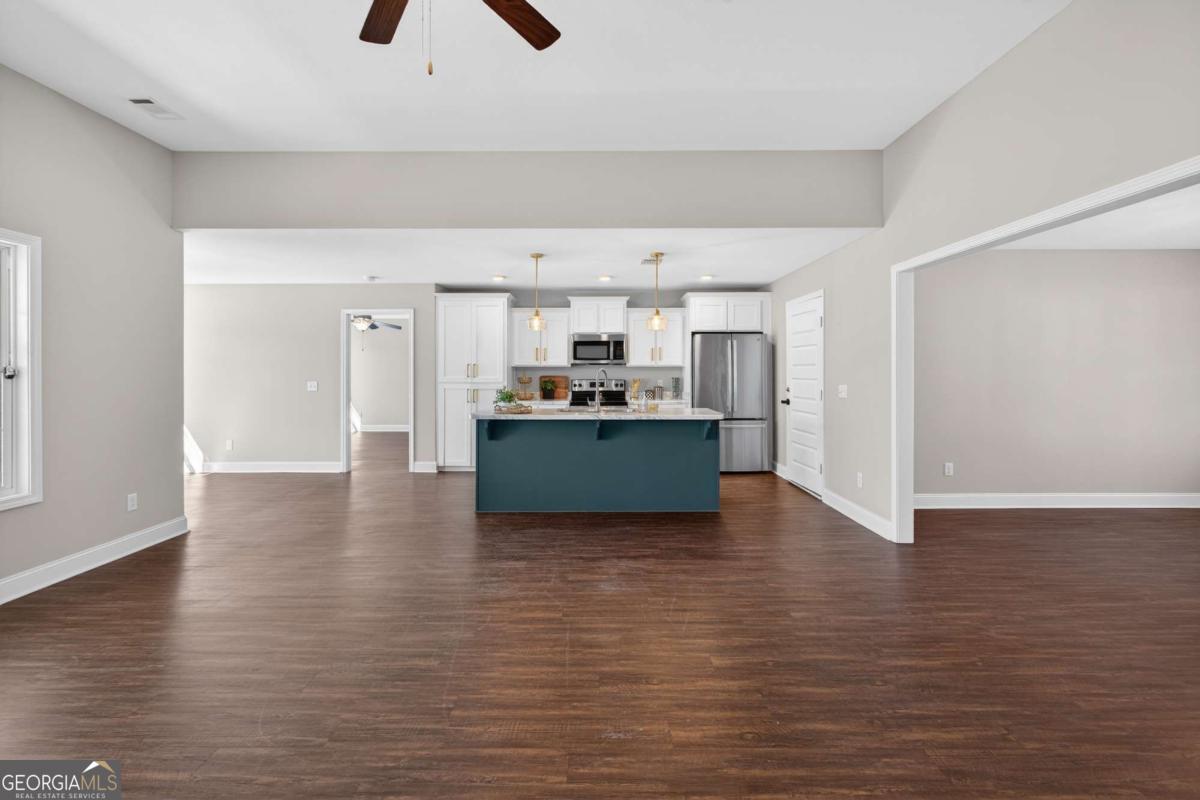 303 Tallulah Bend Ellabell, GA 31308 - Photo 12 of 48 a kitchen with stainless steel appliances granite countertop a refrigerator and a stove top oven