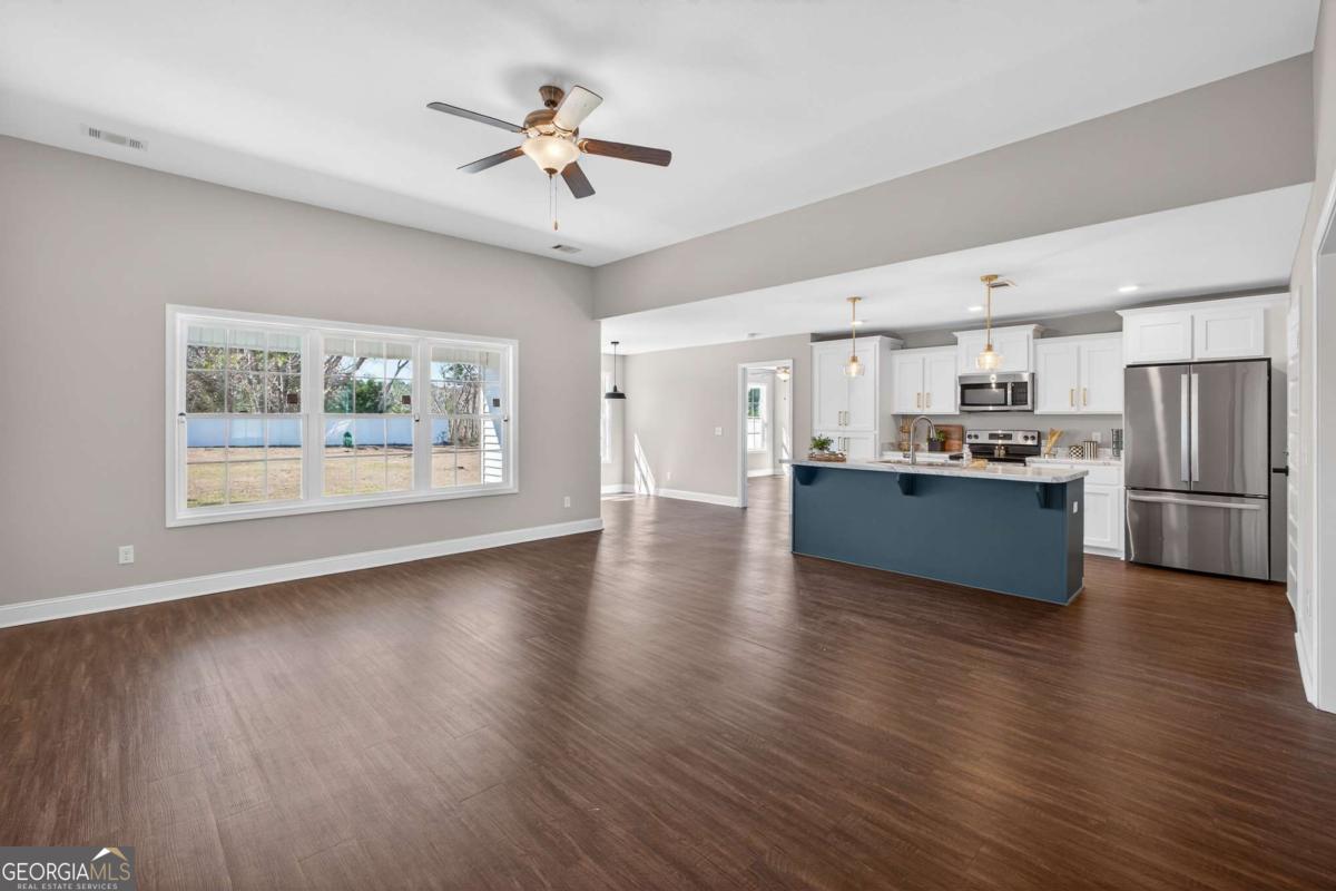 303 Tallulah Bend Ellabell, GA 31308 - Photo 14 of 48 a view of kitchen with refrigerator stove and wooden floor