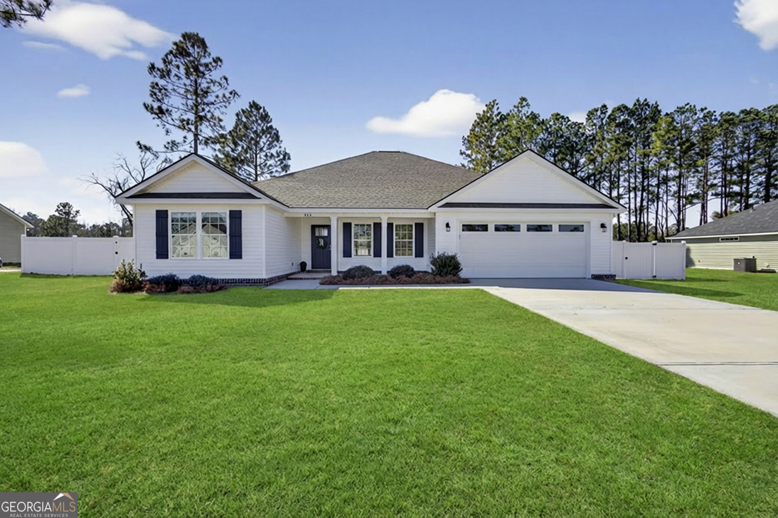 303 Tallulah Bend Ellabell, GA 31308 - Photo 2 of 48 a front view of a house with a garden and yard