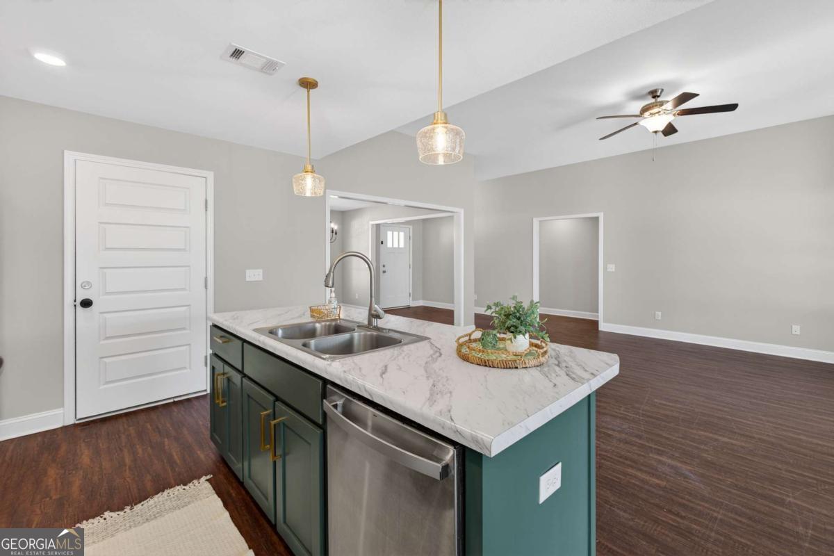 303 Tallulah Bend Ellabell, GA 31308 - Photo 21 of 48 a kitchen with a sink a counter space and wooden floor