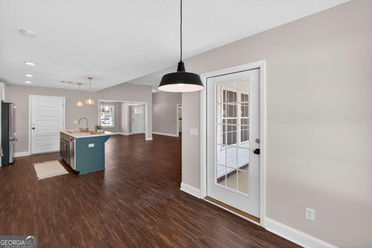 303 Tallulah Bend Ellabell, GA 31308 - Photo 26 of 48 a view of a kitchen and dining room with wooden floor