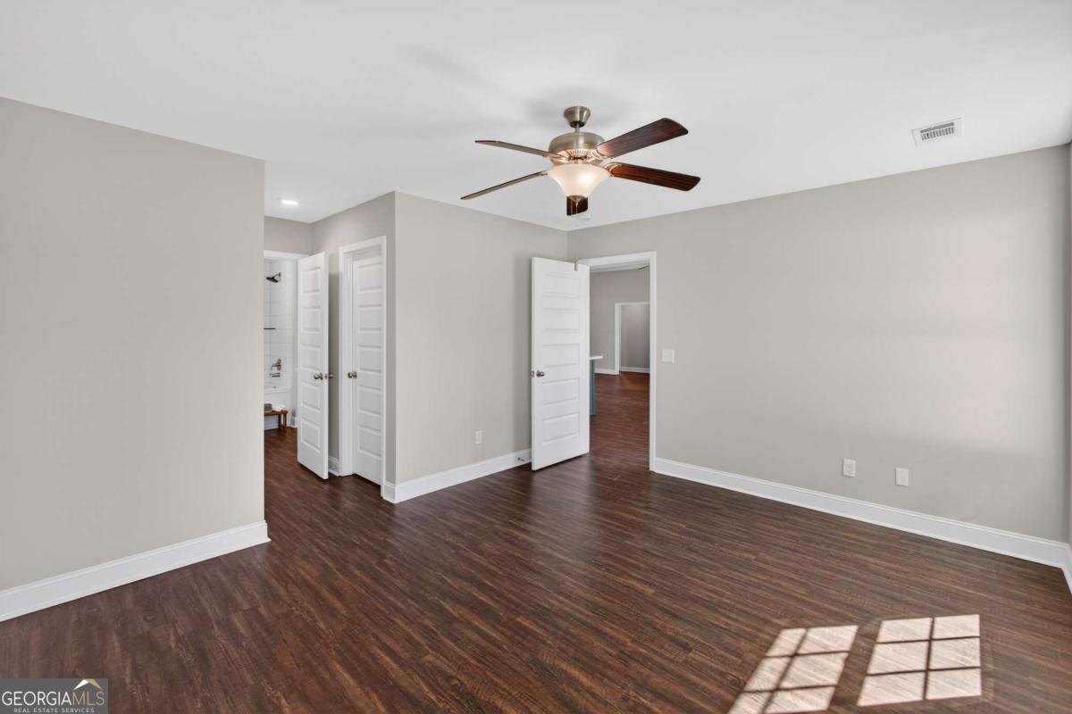303 Tallulah Bend Ellabell, GA 31308 - Photo 28 of 48 a view of an empty room with wooden floor