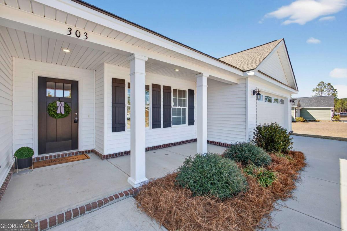 303 Tallulah Bend Ellabell, GA 31308 - Photo 3 of 48 a view of house with potted plants