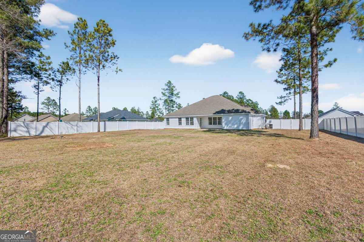 303 Tallulah Bend Ellabell, GA 31308 - Photo 43 of 48 a view of a house with a yard and tree s