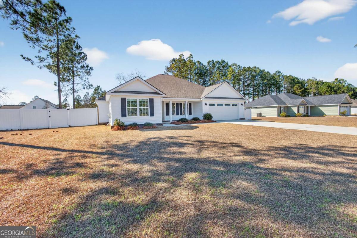 303 Tallulah Bend Ellabell, GA 31308 - Photo 47 of 48 a front view of a house with a yard