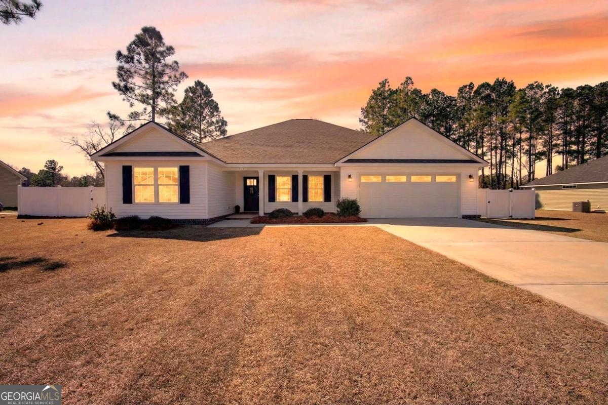 303 Tallulah Bend Ellabell, GA 31308 - Photo 48 of 48 a front view of a house with a yard
