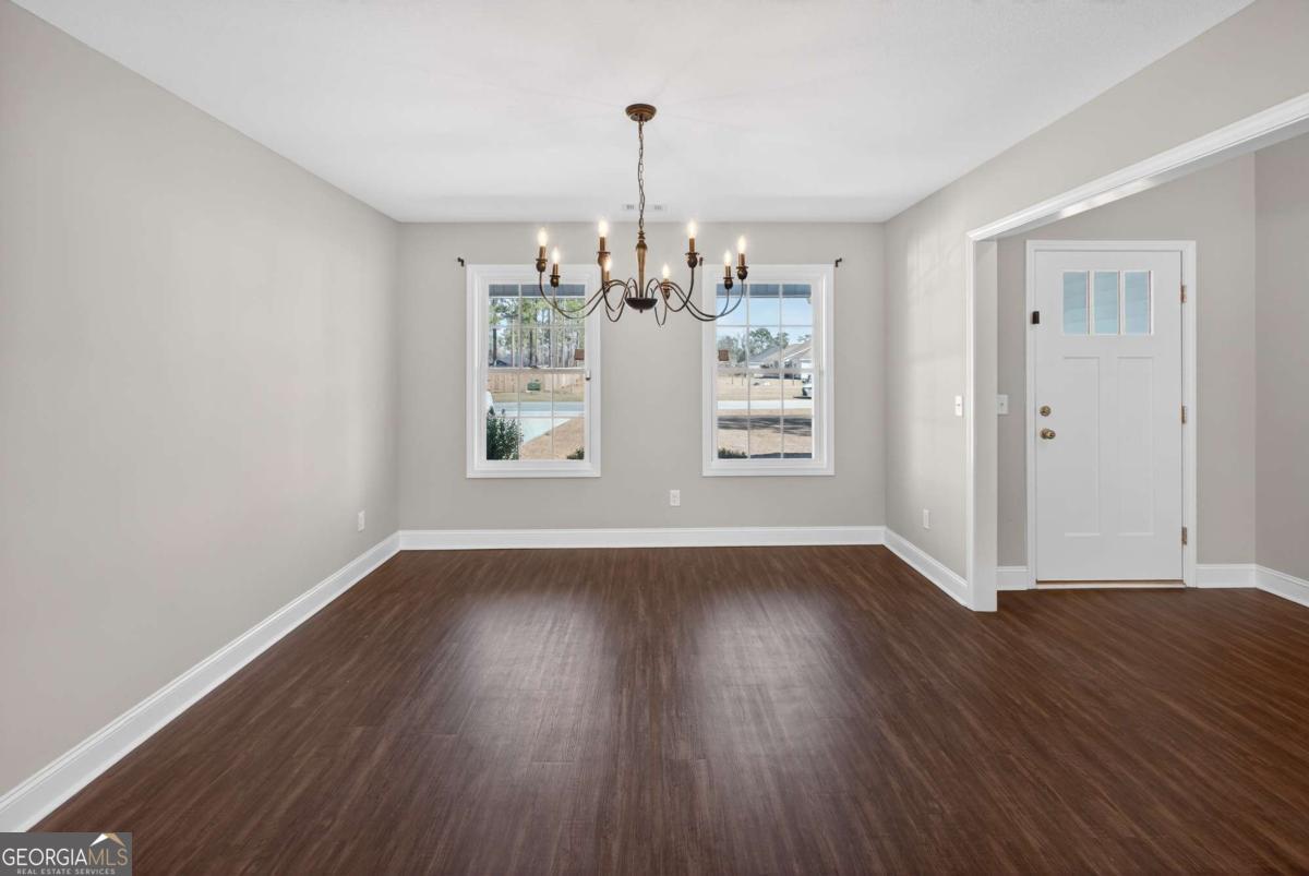 303 Tallulah Bend Ellabell, GA 31308 - Photo 8 of 48 a view of wooden floor and windows in a room