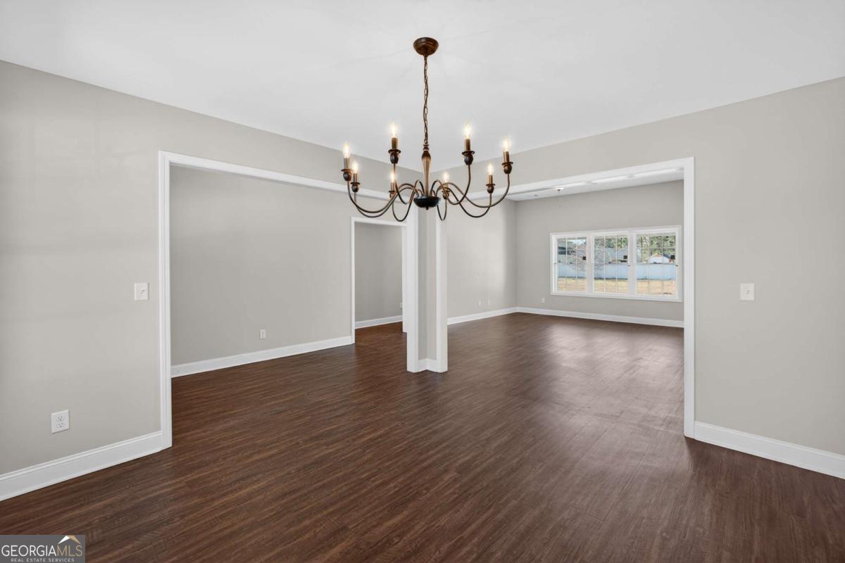 303 Tallulah Bend Ellabell, GA 31308 - Photo 10 of 48 a view of a room with wooden floor chandelier and window
