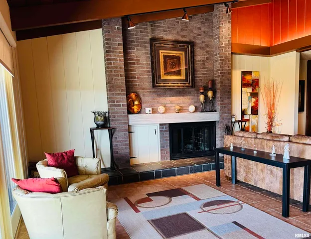 a living room with furniture a ceiling fan and a rug