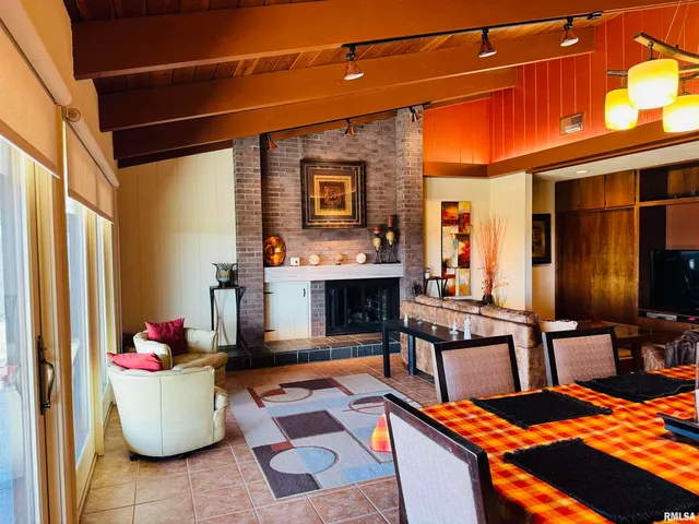 a view of a dining room with furniture and a chandelier