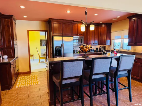 a kitchen with stainless steel appliances granite countertop a sink a counter top space and cabinets