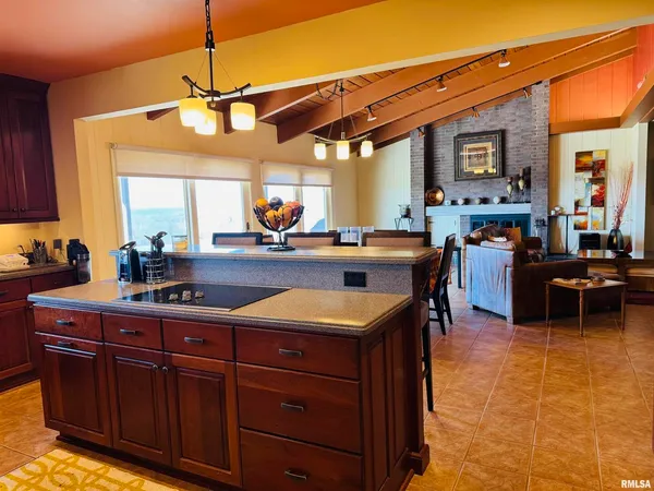 a kitchen with stainless steel appliances granite countertop a sink a stove and a refrigerator