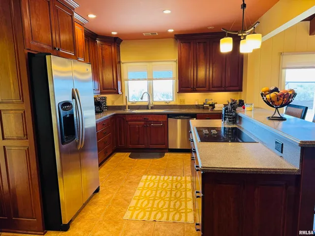 a living room with couches and kitchen view