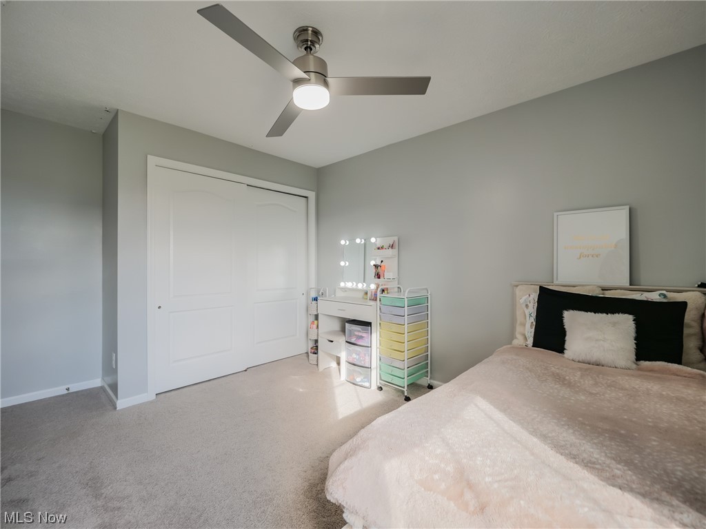 37571 Amber Way North Ridgeville, OH 44039 - Photo 21 of 35 Bedroom featuring light carpet, ceiling fan, and a closet