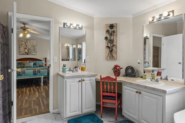 a bathroom with a sink vanity and mirror