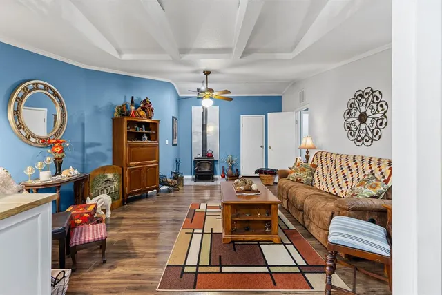 a living room with furniture a rug and a chandelier