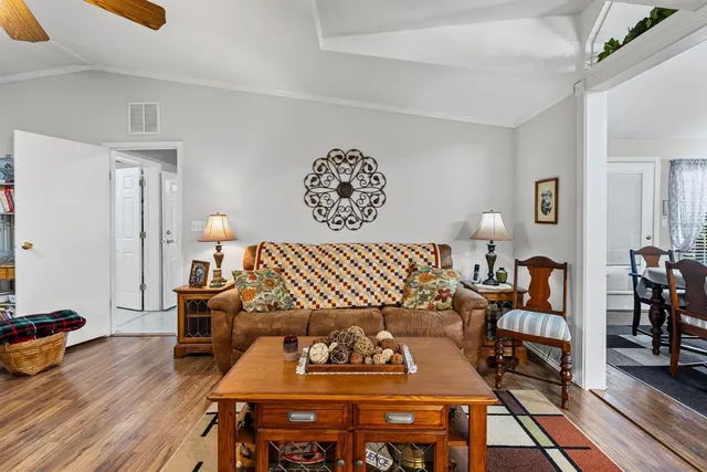 a living room with furniture a rug and a wooden floor