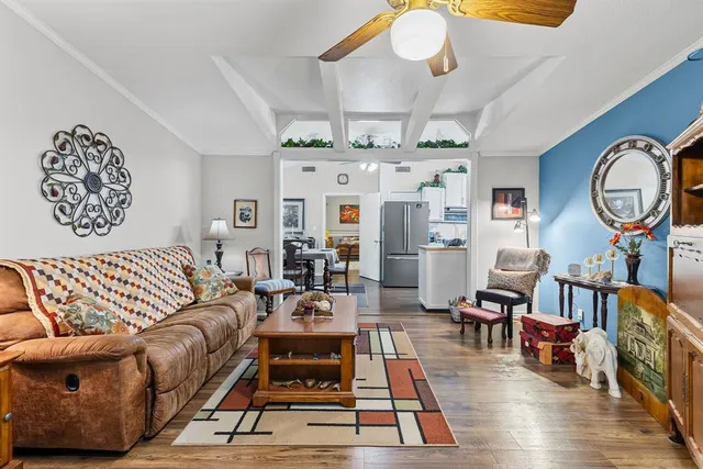 a living room with furniture a rug and white walls
