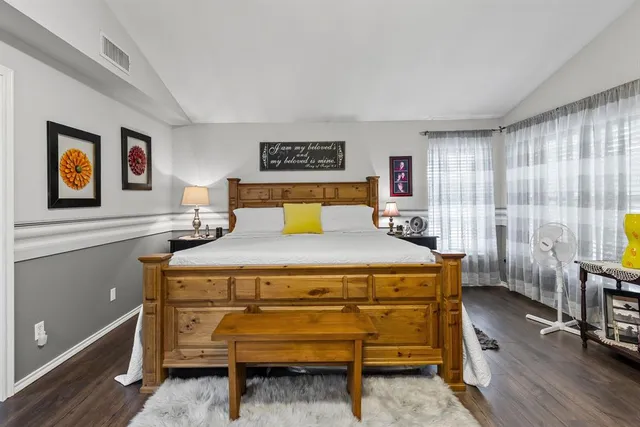 a bedroom with a bed and a flat screen tv