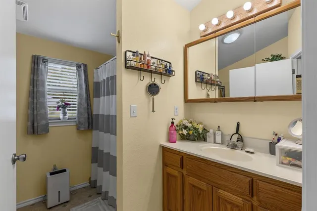 a bathroom with a sink a toilet and mirror