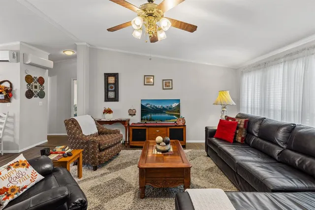 a living room with furniture a rug and a flat screen tv