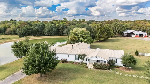 an aerial view of a house with outdoor space