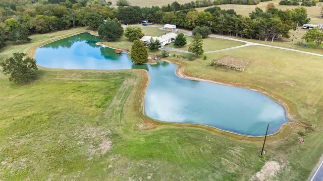 a view of a swimming pool with a yard