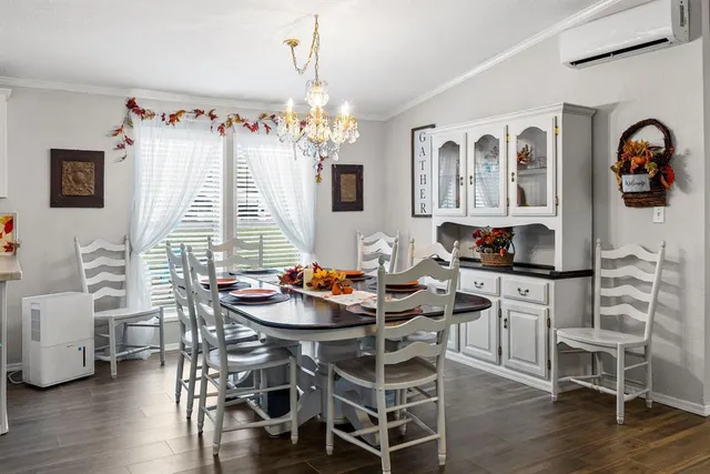 a dining room with furniture wooden floor and a chandelier