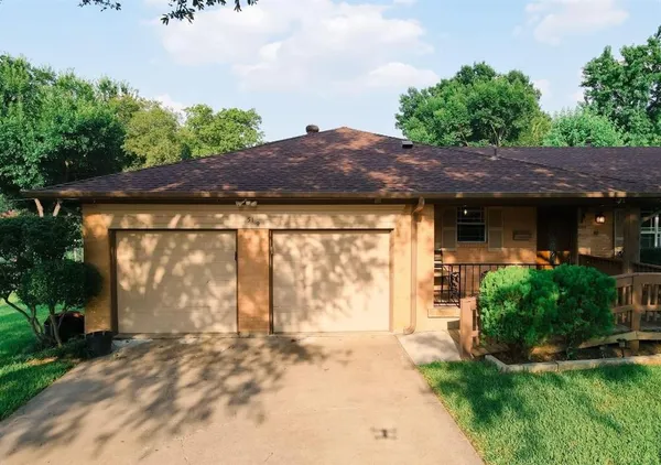 a view of house with backyard and garden
