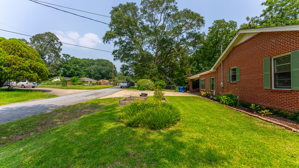 5352 Moon Road Columbus, GA 31909 - Photo 16 of 50 a backyard of a house with plants and large trees