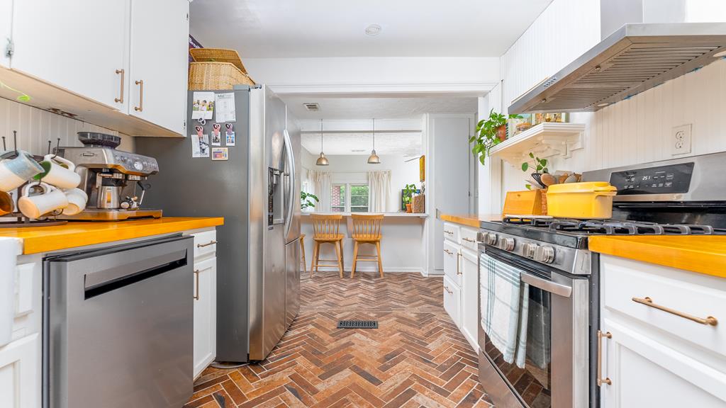 5352 Moon Road Columbus, GA 31909 - Photo 24 of 50 a kitchen with stainless steel appliances granite countertop a stove a sink and a refrigerator
