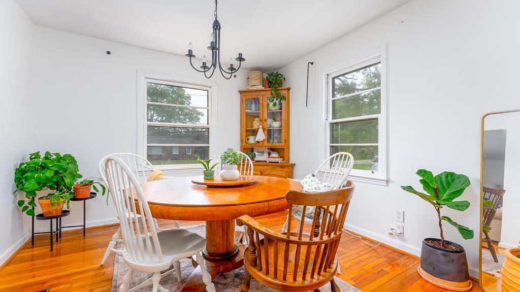 5352 Moon Road Columbus, GA 31909 - Photo 25 of 50 a dining room with furniture potted plants and wooden floor