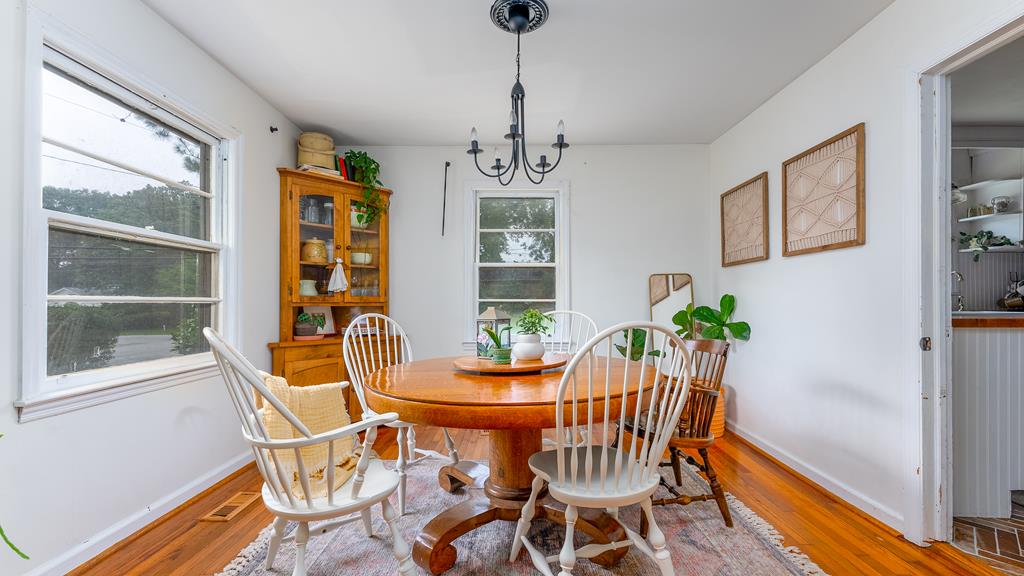 5352 Moon Road Columbus, GA 31909 - Photo 26 of 50 a dining room with furniture a chandelier and wooden floor