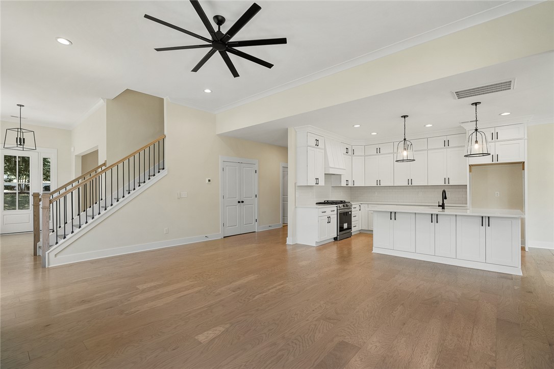 100 Garden Gate Drive Anderson, SC 29621 - Photo 11 of 43 This bright, open-concept living area features a modern kitchen and inviting staircase.